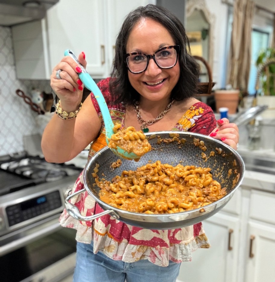woman holding a spoonful of homemade hamburger helper (