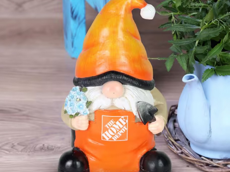 garden gnome holding flowers and tool 