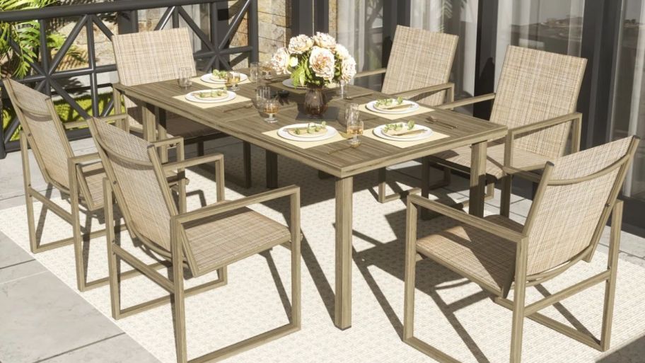 7 piece chairs with table outside on a rug