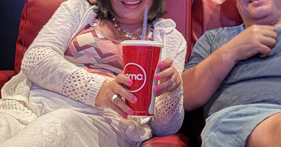 AMC Cup with drink being held in a movie theater