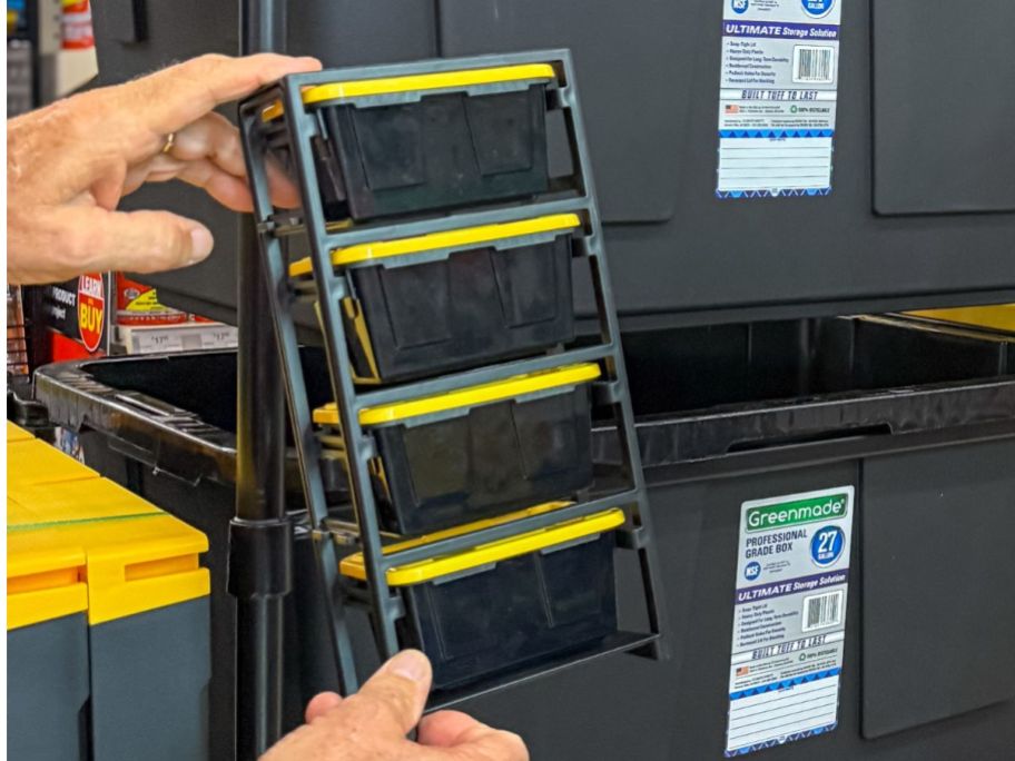 hand holding Ace Hardware 4-Tier Mini Bin Storage Tote Rack in store