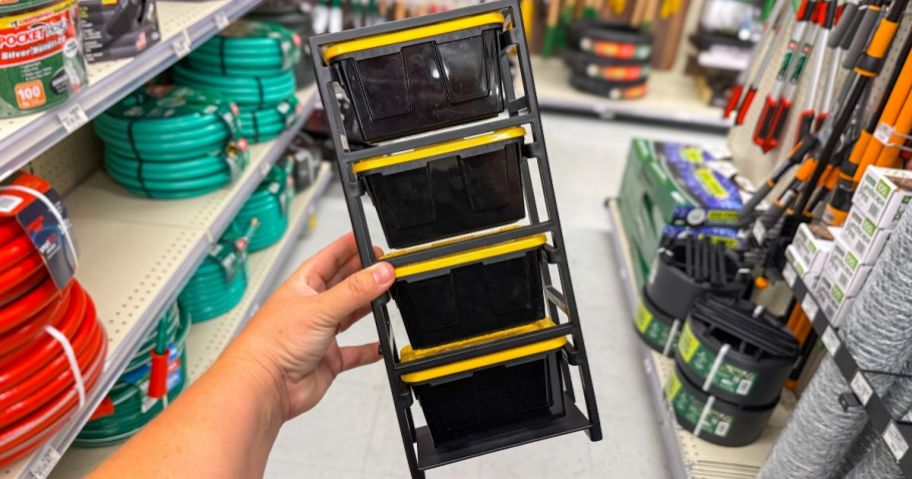 hand holding Ace Hardware 4-Tier Mini Bin Storage Tote Rack in store