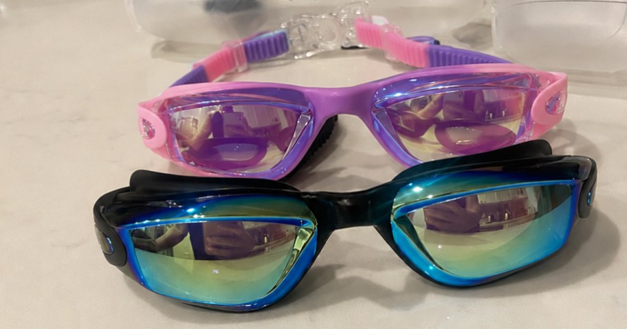 pink and black pairs of goggles on a counter