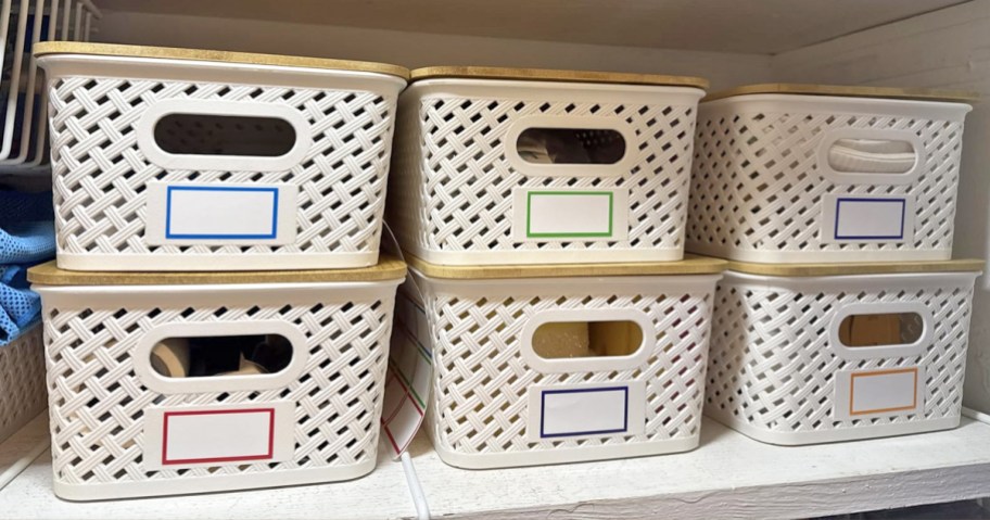 6 plastic storage bins on a shelf in closet