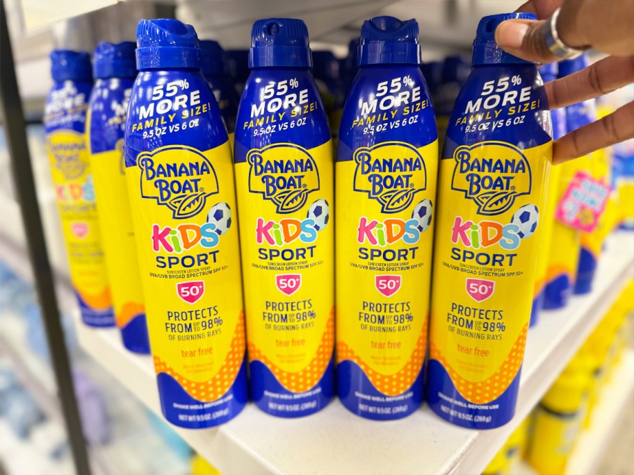 four yellow and blue cans of Banana&nbsp;Boat Kids Sport Sunscreen Sprays on shelf