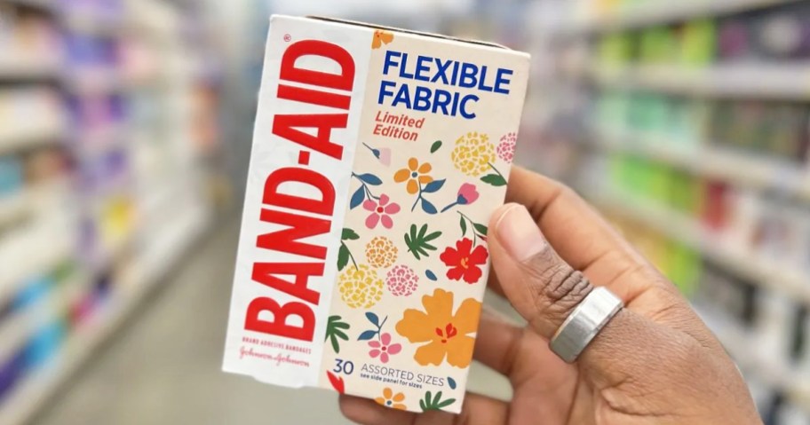 hand holding up a box of Band-Aid Wildflower Bandages
