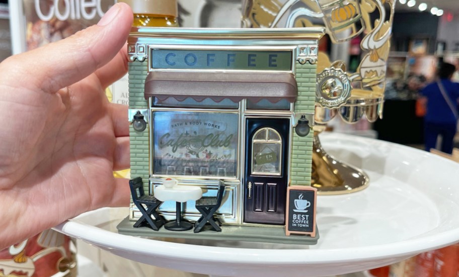 hand holding a coffee shop themed fragrance plug