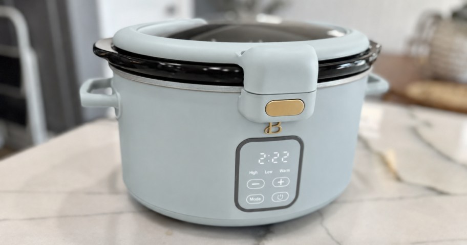 beautiful by drew slow cooker in blue sitting on kitchen countertop