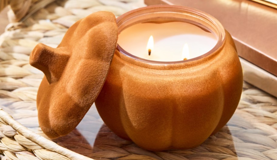 orange flocked pumpkin jar candle in a tray