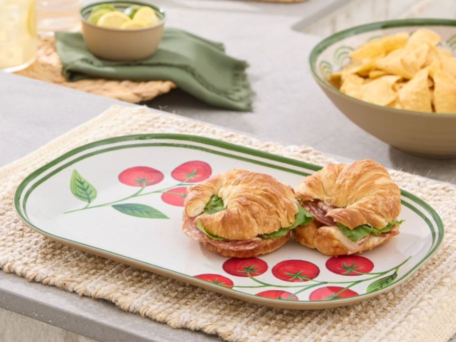 Better homes and gardens Melamine serving tray with tomato design on it with a croissant sandwich on it