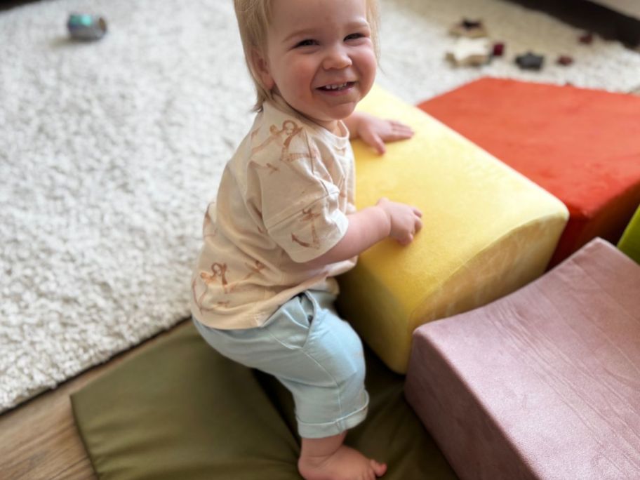 A baby boy wearing a Burt's Bees Baby 2-piece outfit with anchors on it