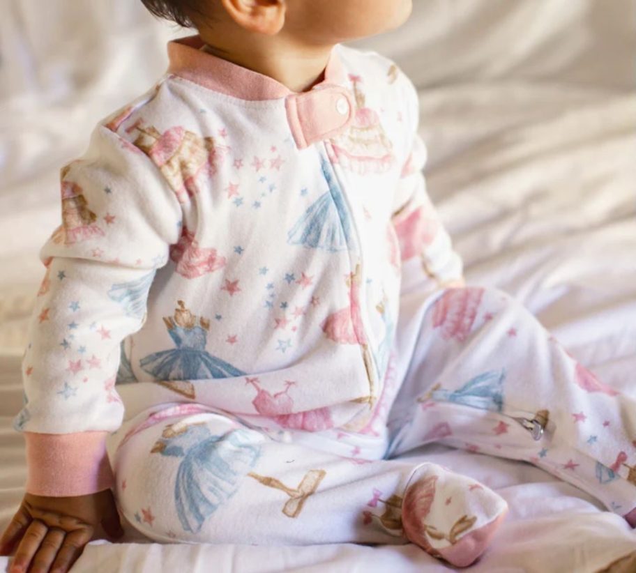 A baby wearing Burt's Bees baby one-piece pajamas