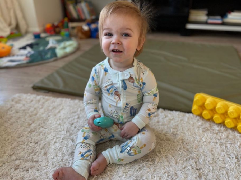 baby sitting on the floor wearing Burt's Bees Baby Popsicle Print Pajamas