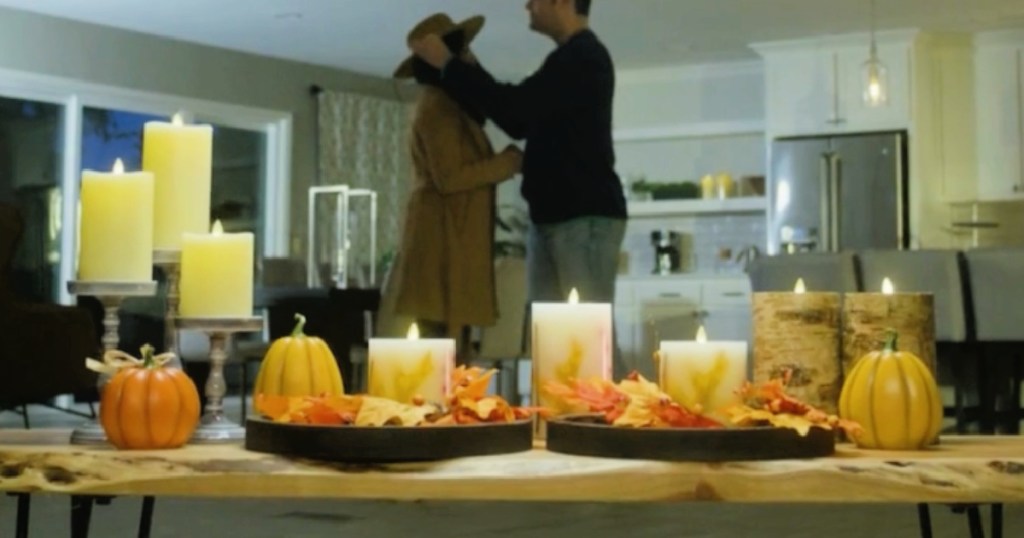 Flameless candles on display in living room, surrounded by fall accessories