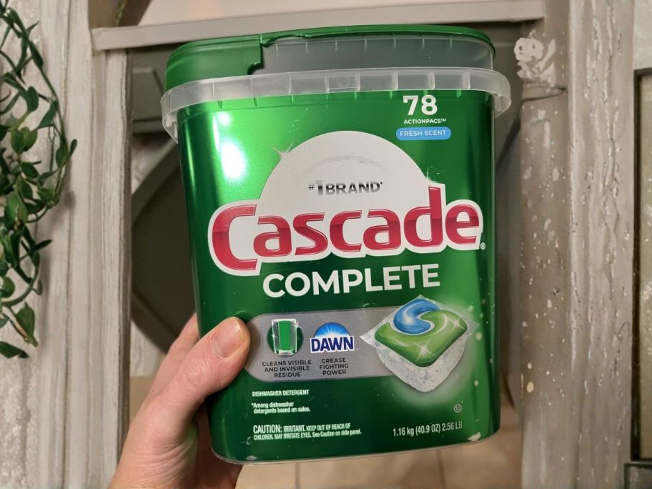 Cascade Complete Dishwasher Pods 78-Count in hand in kitchen