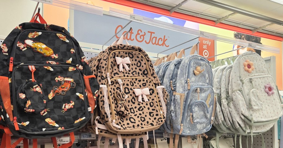 kids printed backpacks on store display wall