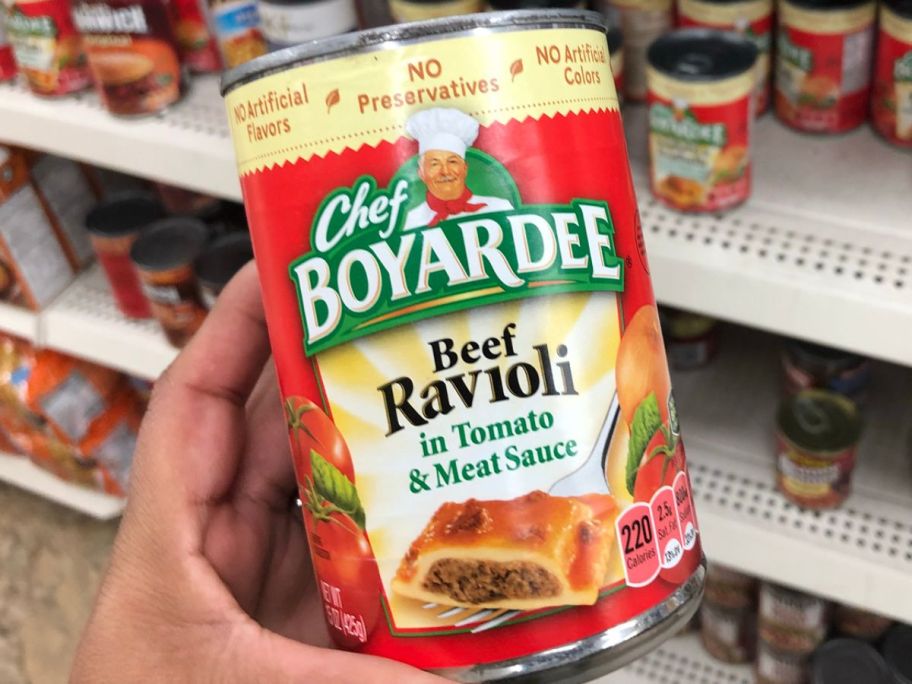 Hand holding a can of Chef Boyardee Ravioli