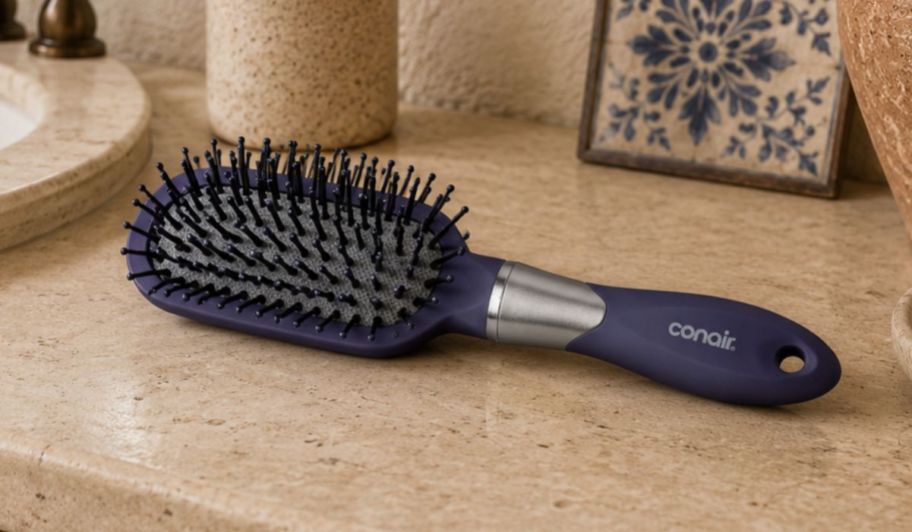 Conair hair brush purple in bathroom