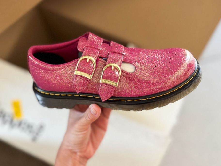 hand holding pink Dr. Martens Kids' Collection 8065 J Girls' Shoe