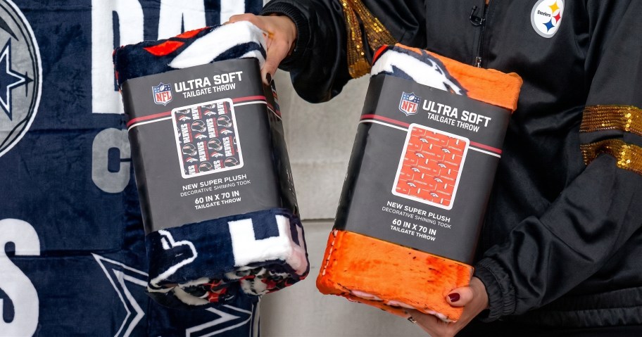 Woman holding two Sets of NFL Throw Blankets