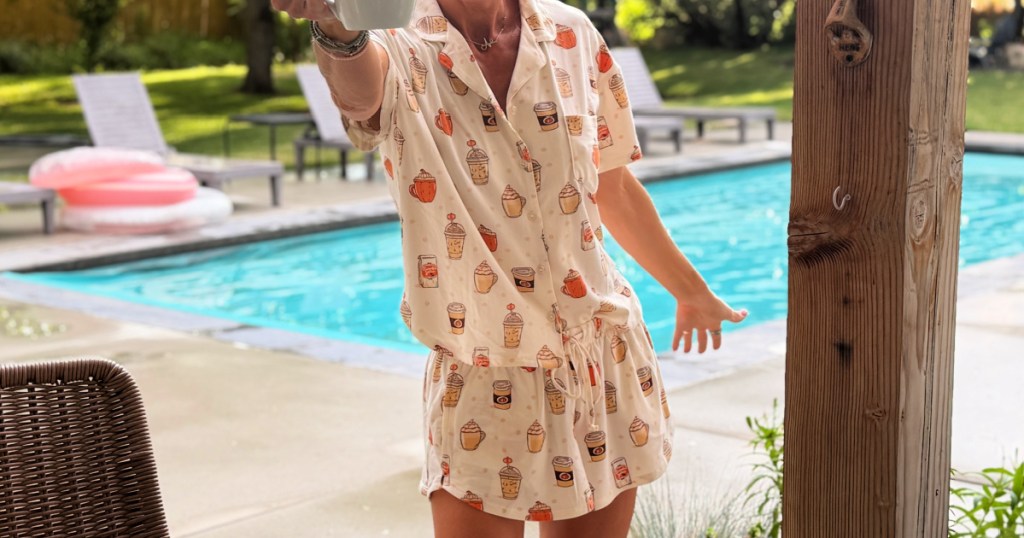woman in halloween pajamas holding coffee mug
