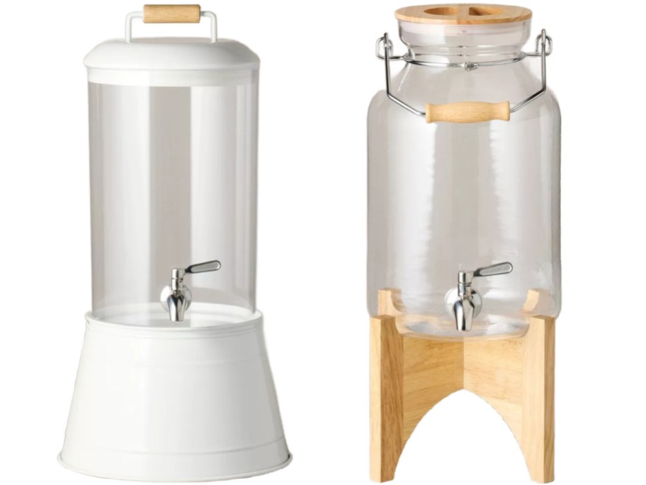 Two clear beverage dispensers with metal spigots against a white background; one features a white base and lid, while the other sits on a wooden stand with a matching wooden lid.