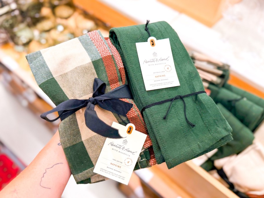 holding two sets of cloth napkins