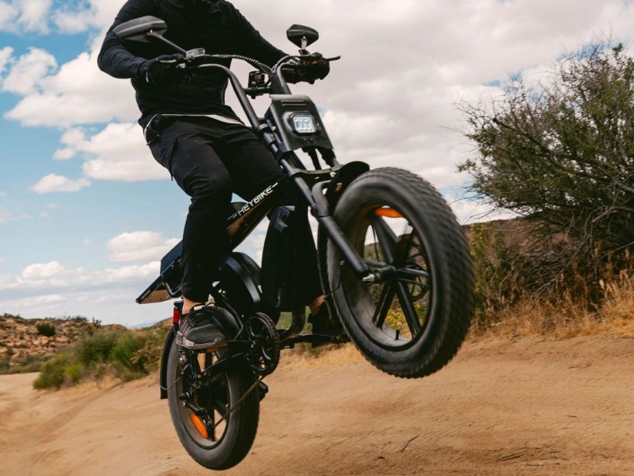person riding Heybike Saturn eBike on one wheel