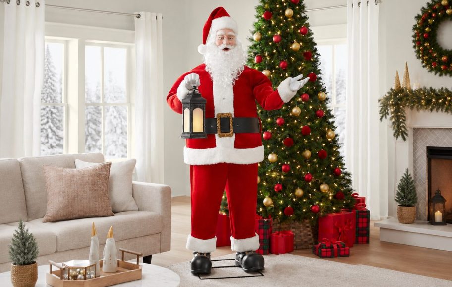 App-controlled Santa holding a lantern beside a decorated Christmas tree