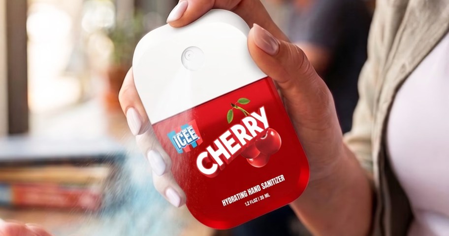 hand spraying red icee cherry hand sanitizer spray