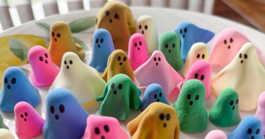 various colors of air dried clay formed to create cute Halloween ghosts on a table