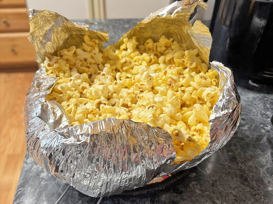 popcorn inside a foil Jiffy Pop pan on counter