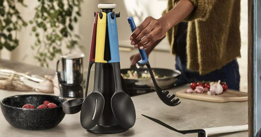 woman grabbing utensil from Joseph Joseph Elevate Carousel 6-Piece Utensil Set w/ Rotating Storage Stand in kitchen