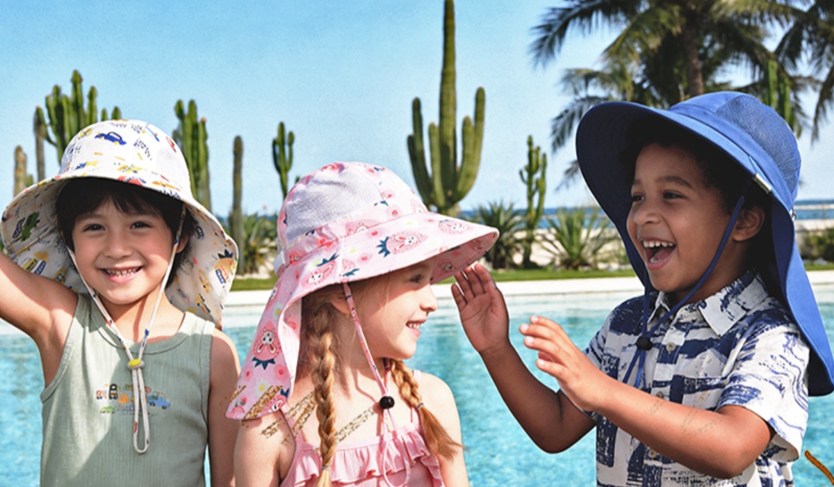Three kids wearing sun hats that have neck flaps.