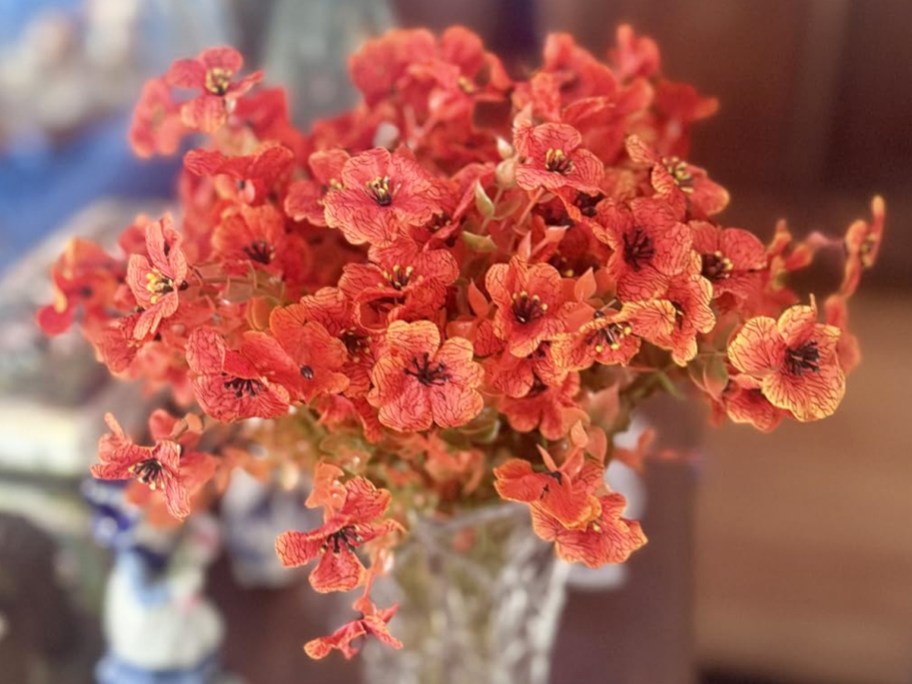 orange artificial flowers in a vase