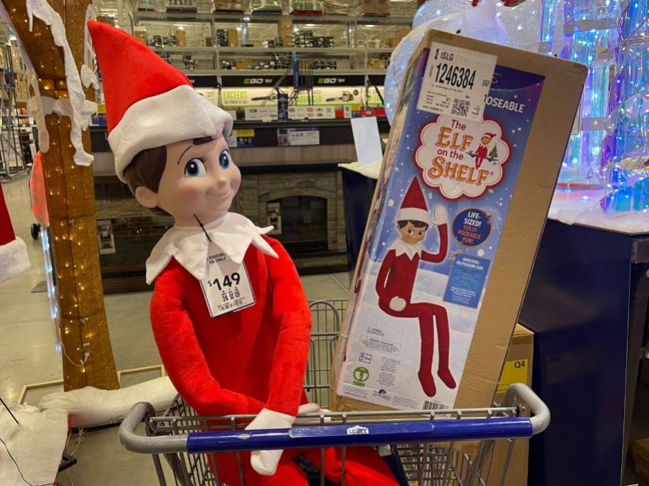 A Lowe's Cart with a Giant Elf on the Shelf in the front