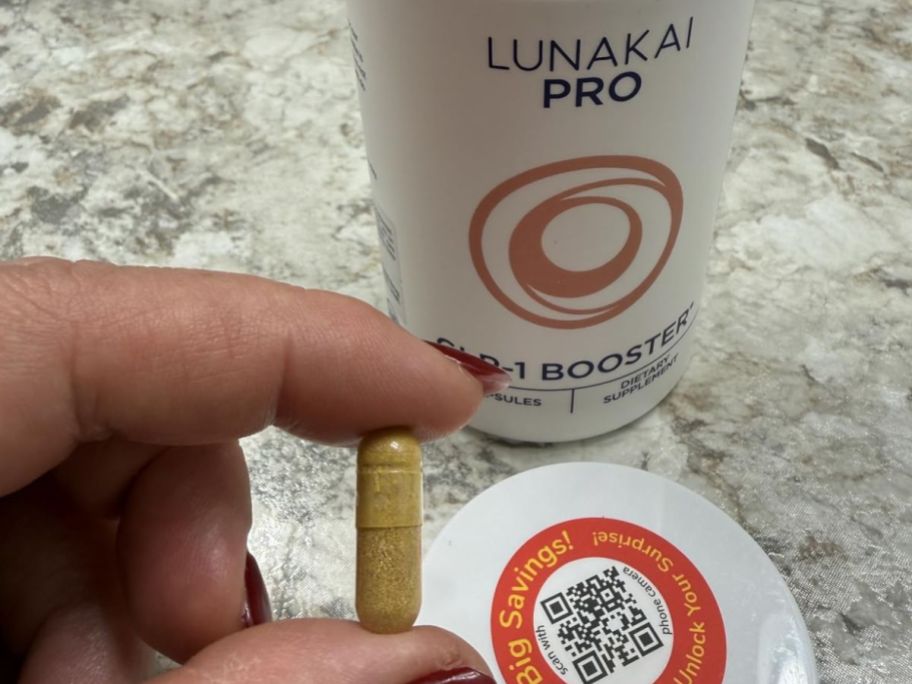 Hand holding a Lunakai Pro GLP-1 Booster Capsule