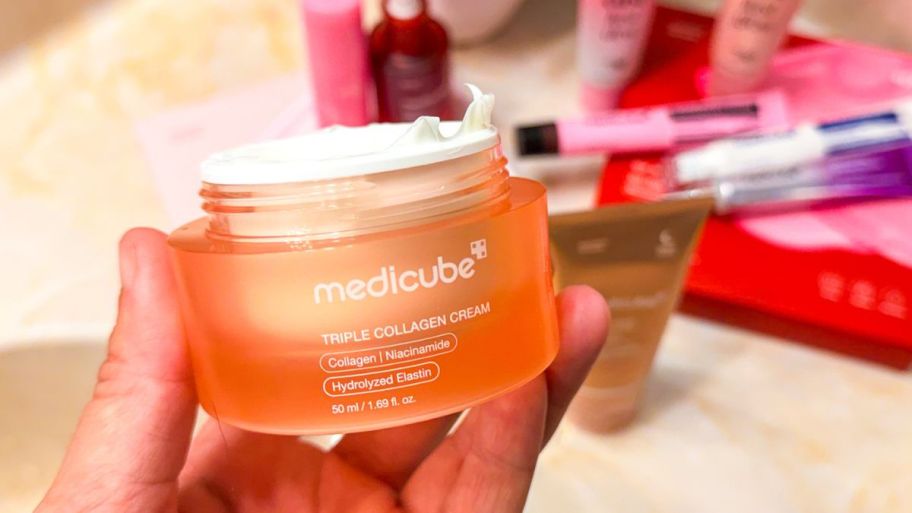 hand holding newmedicube triple collagen moisturizer