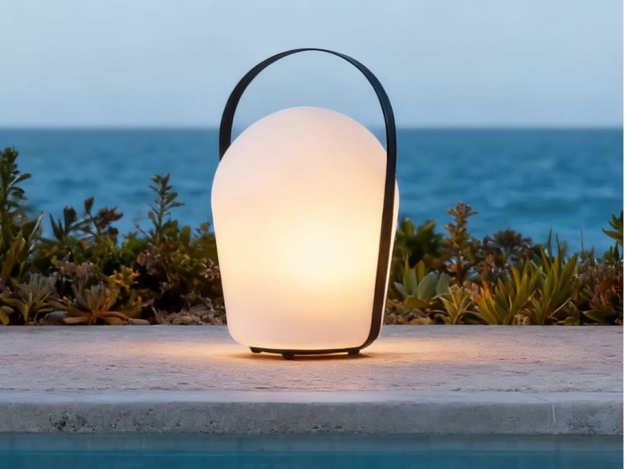 Member's Mark Color Changing 15" Outdoor Lantern next to a pool