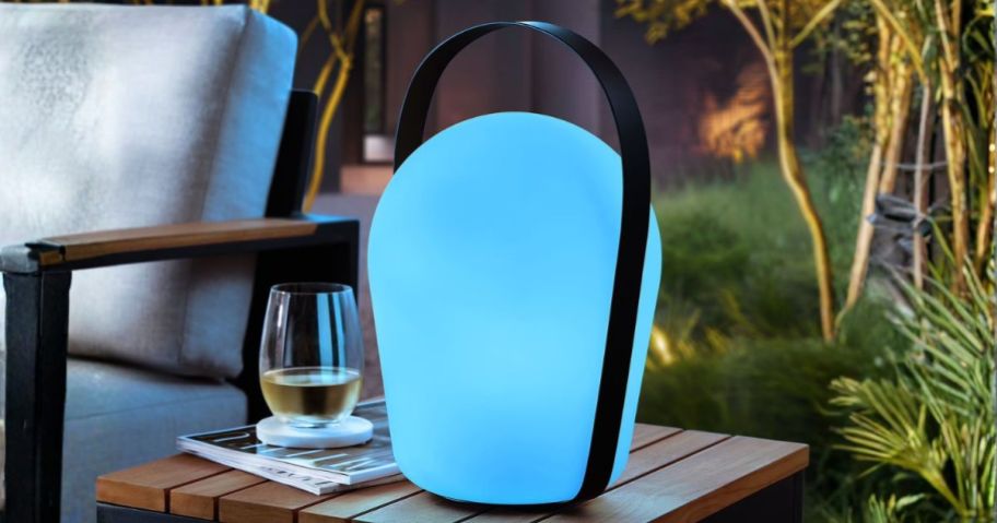 Member's Mark Color Changing 15" Outdoor Lantern in blue on patio