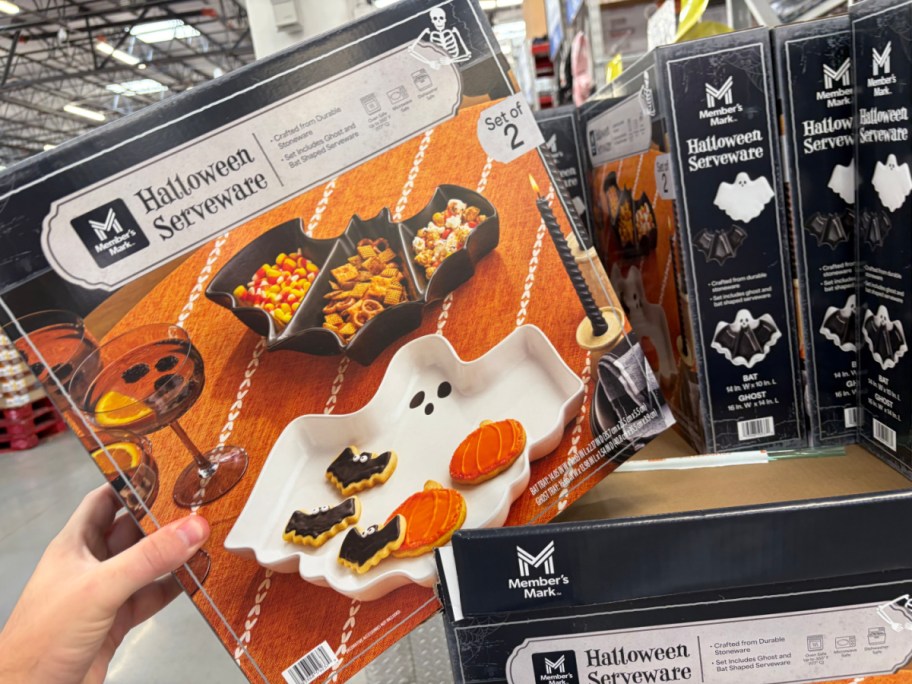 A box of Member's Mark Halloween Serveware featuring a set of ghost- and bat-shaped serving trays filled with cookies.