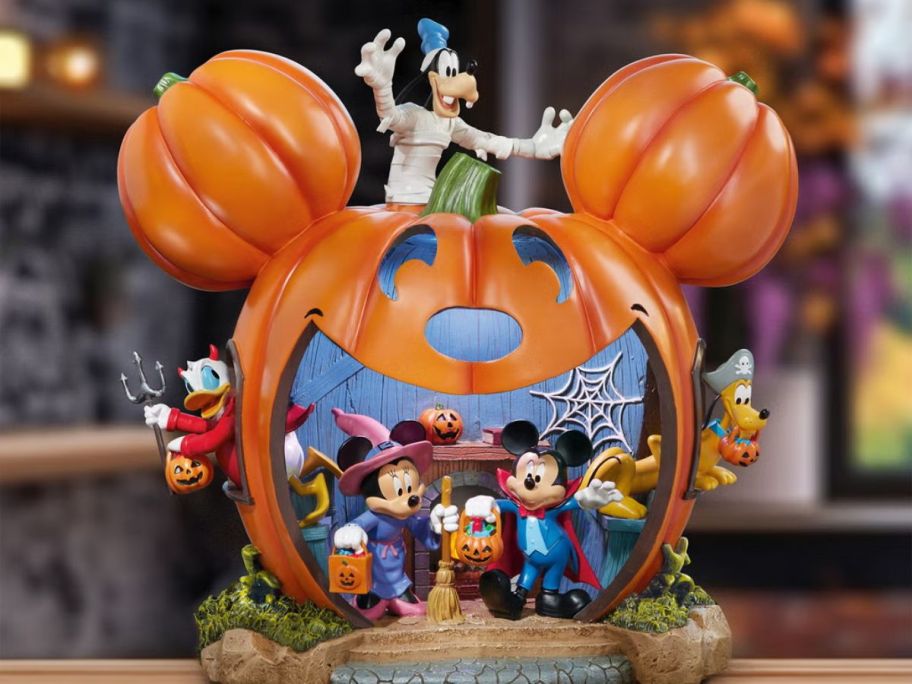 Mickey mouse disney pumpkin animated and lighted on a table
