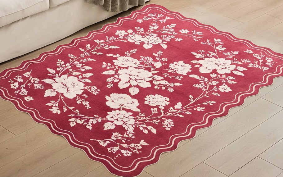 red white and green floral print rug in front of a sofa