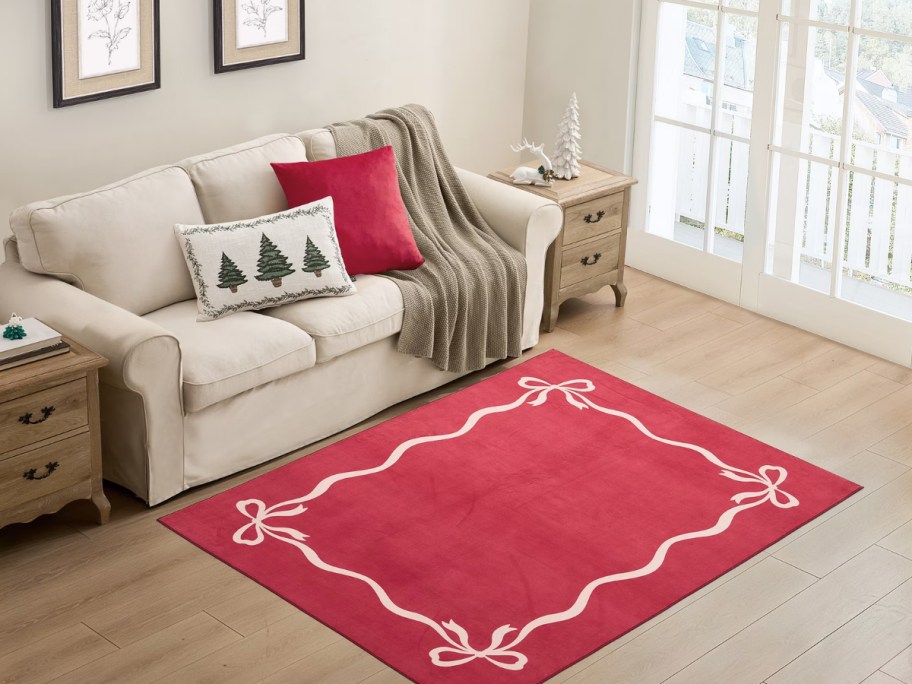 red and white and bow design rug in front of a sofa