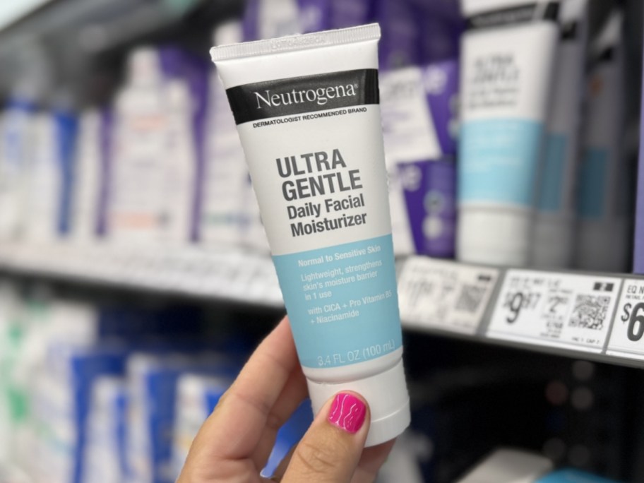 person holding Neutrogena SPF 30 Ultra Gentle Daily Face Moisturizer 3.4oz bottle at walmart