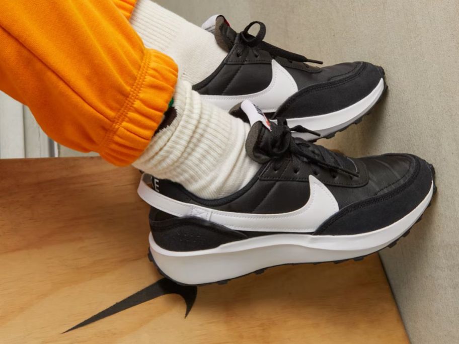 woman wearing black and white Nike Waffle Debut Women's Shoes