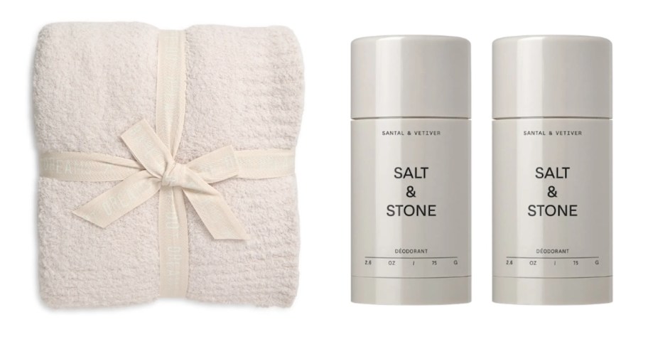 barefoot dreams blanket with ribbon and salt and stone deodorant sticks on white background