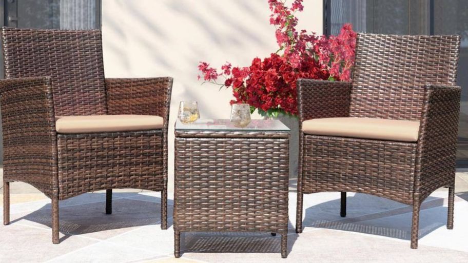 Brown Outdoor 3piece set with beige cushions on it