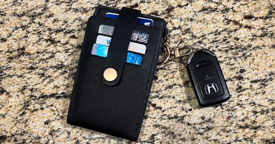 black wallet on counter with car key attached