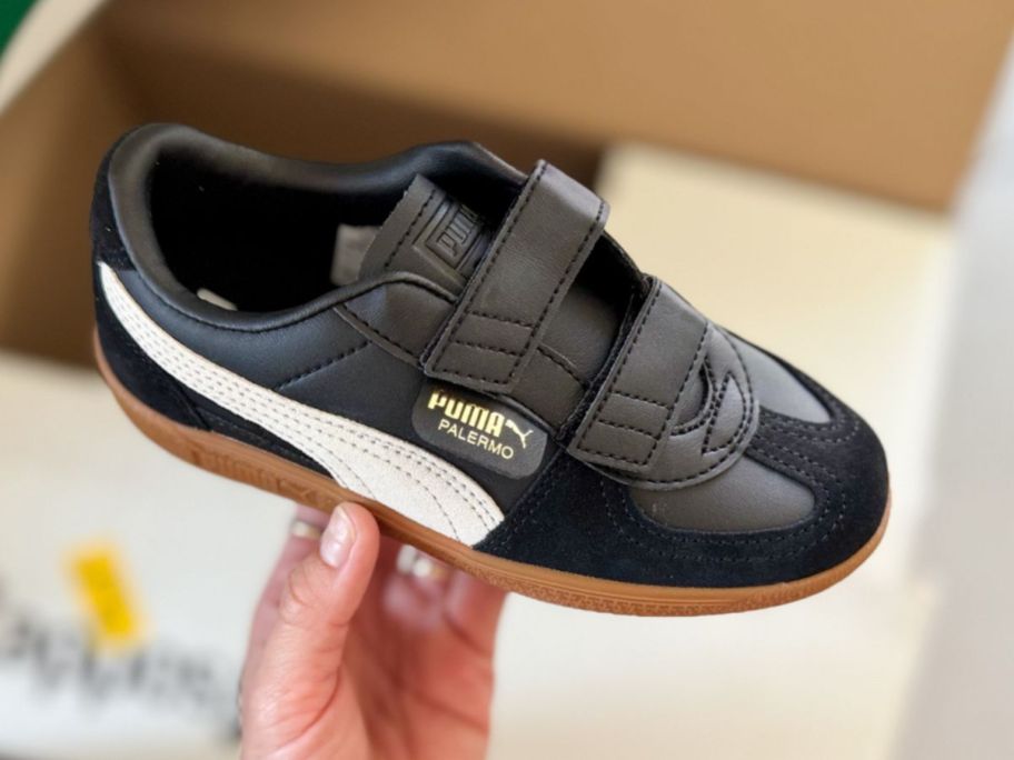 hand holding PUMA Kids Palermo Hook & Loop Shoes in Black